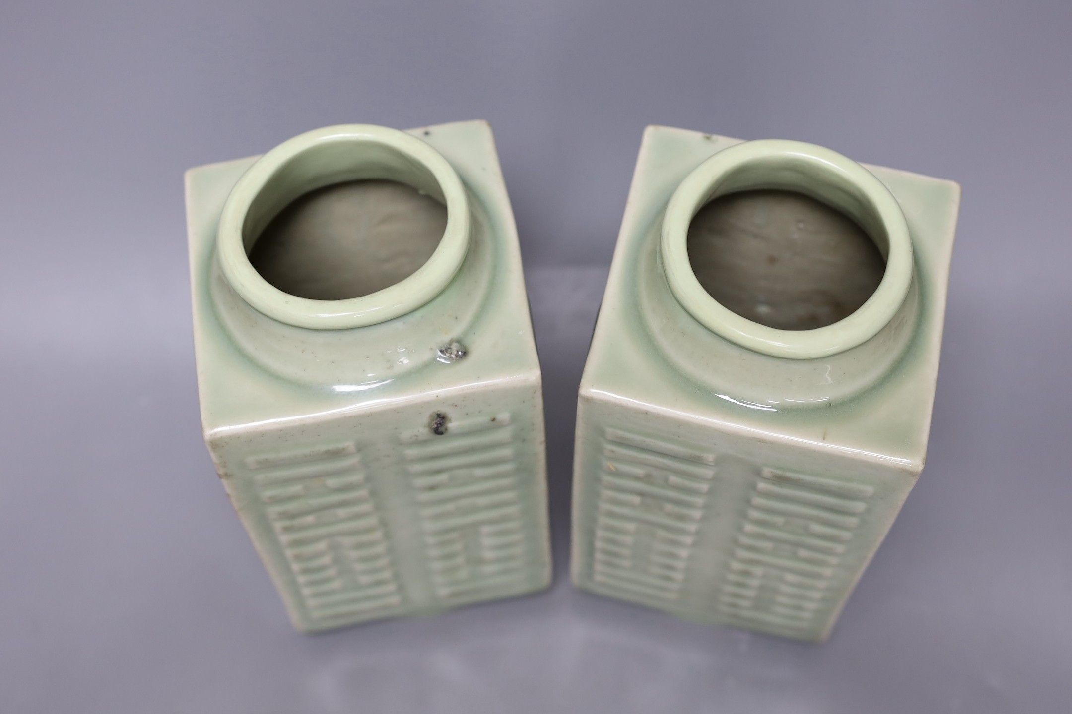 A pair of early 20th century Chinese celadon glazed eight trigrams cong vases, 25cm